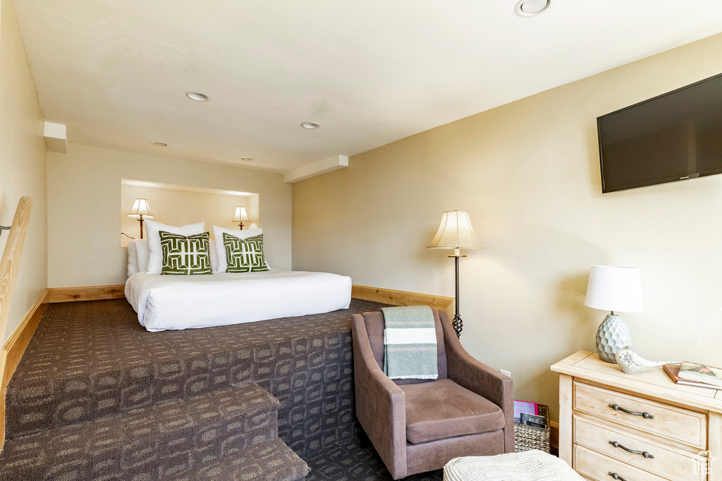 Carpeted bedroom with baseboards and recessed lighting