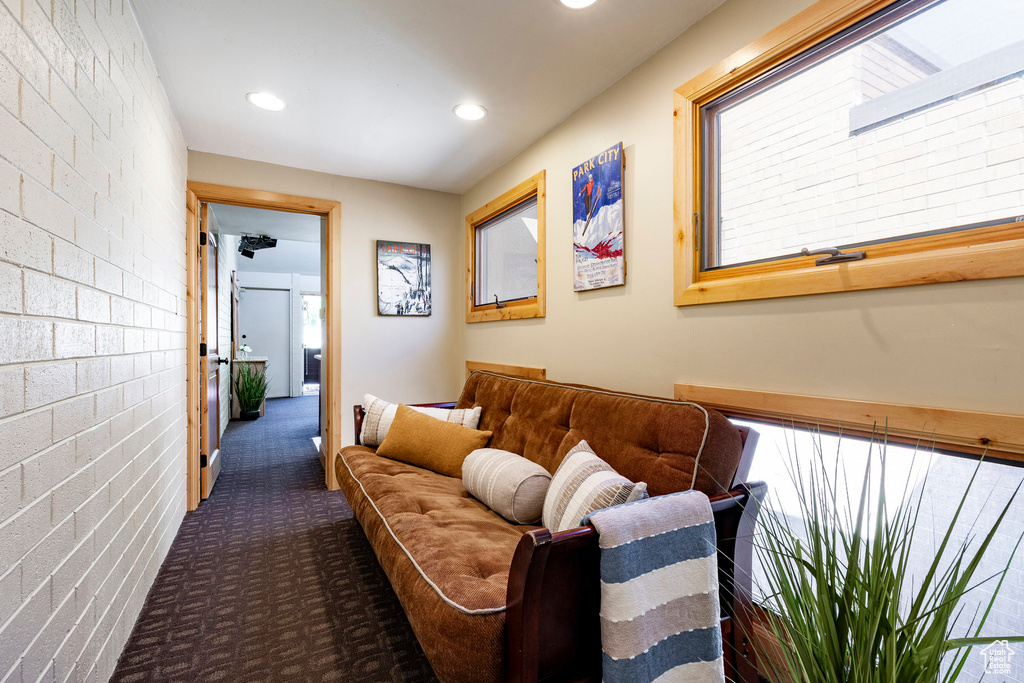 Living room with carpet floors, plenty of natural light, and recessed lighting