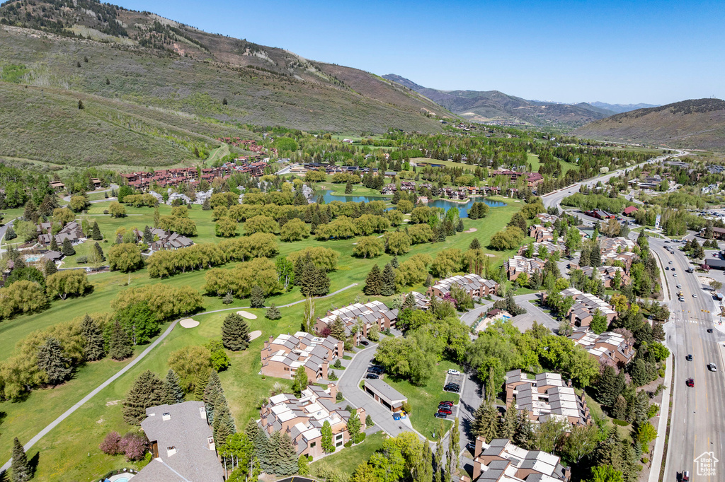 Aerial view of property's location featuring a water and mountain view and nearby suburban area