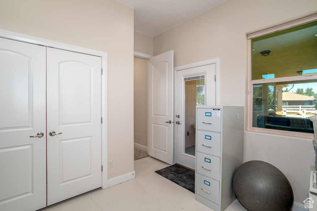 Foyer with plenty of natural light and baseboards