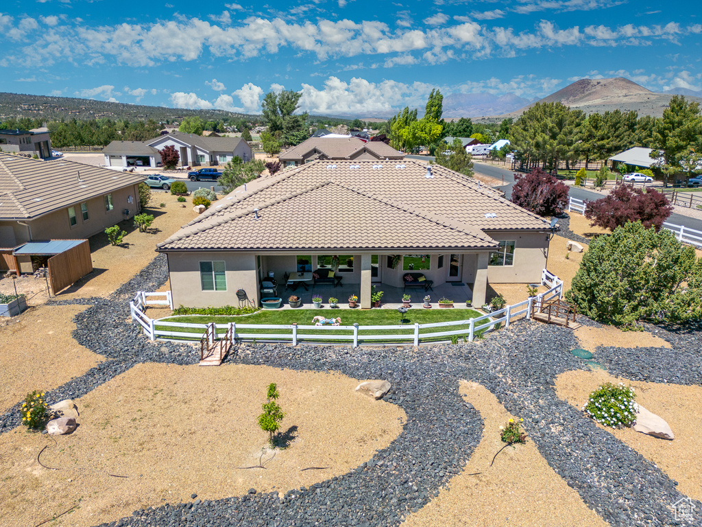 Rear view of property with a fenced backyard, stucco siding, a patio area, and a tile roof