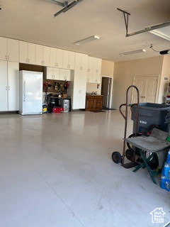 Garage featuring freestanding refrigerator