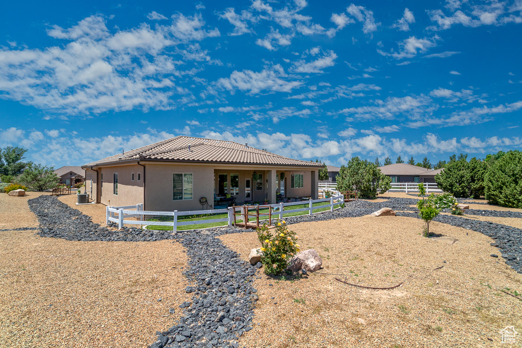 Rear view of property with stucco siding and a tile roof