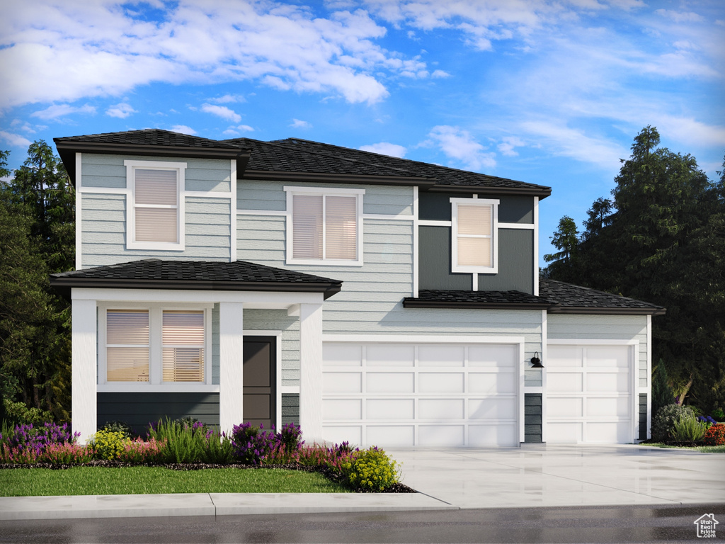 Traditional-style home featuring concrete driveway and an attached garage