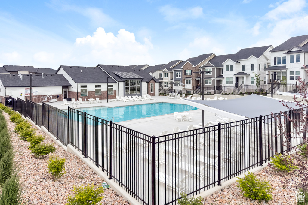 Community pool with a residential view and a patio