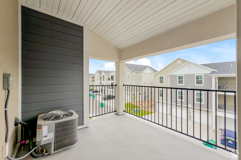 Balcony featuring central AC unit and a residential view