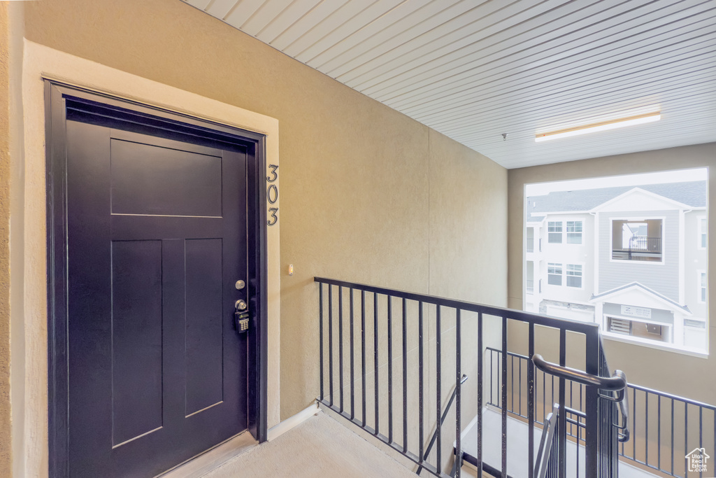 Entrance to property featuring stucco siding and a balcony