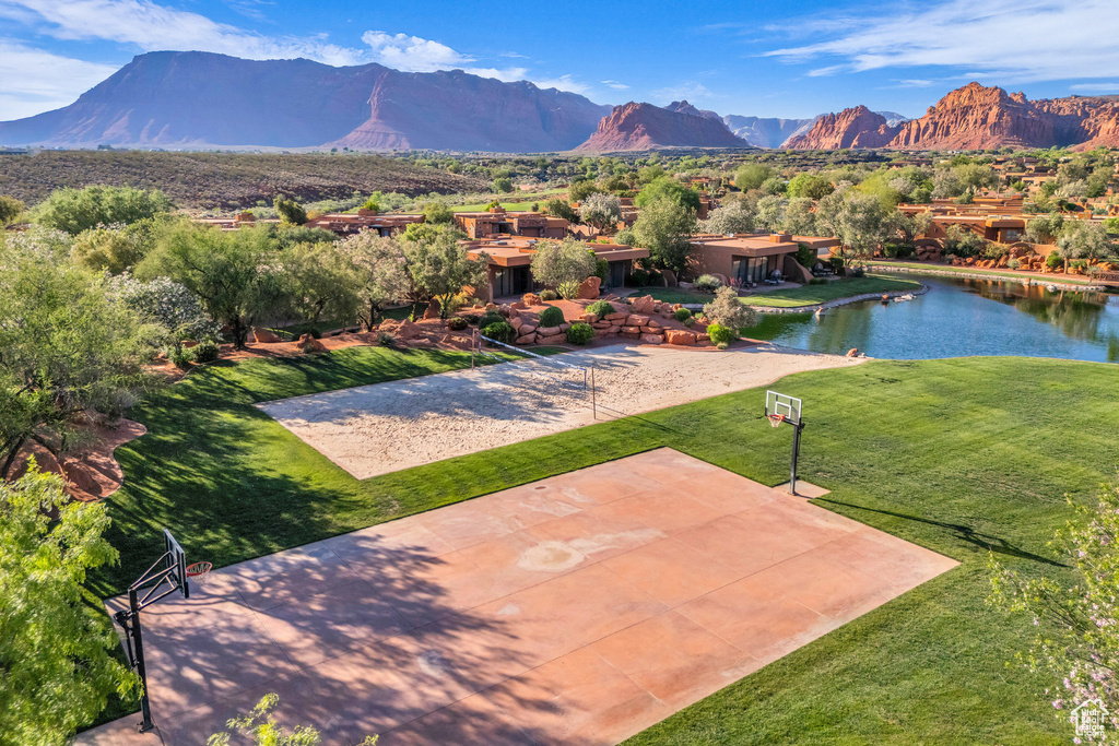 View of patio with a water and mountain view and community basketball court