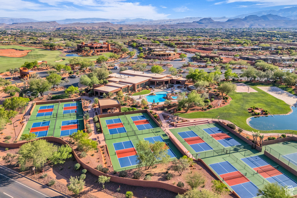 Aerial perspective of suburban area featuring a golf course, a water and mountain view, and a pool
