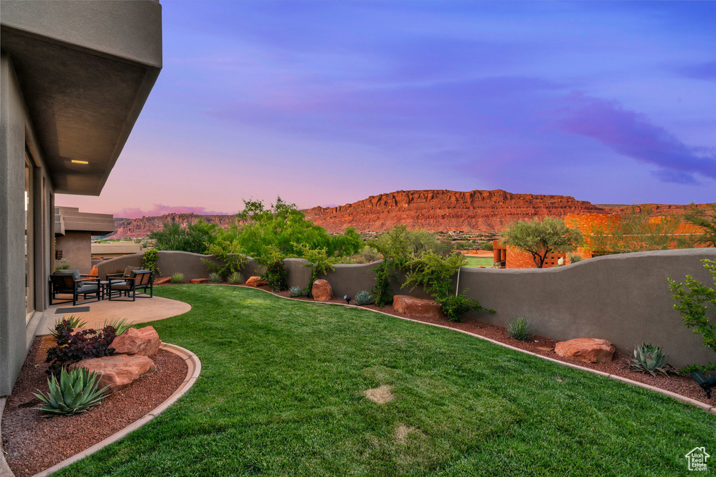 View of yard featuring a patio and a mountain view