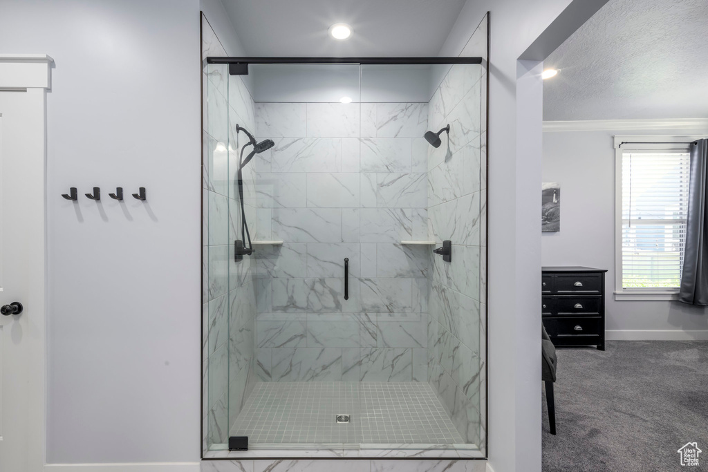 Bathroom with baseboards, a marble finish shower, recessed lighting, and ornamental molding