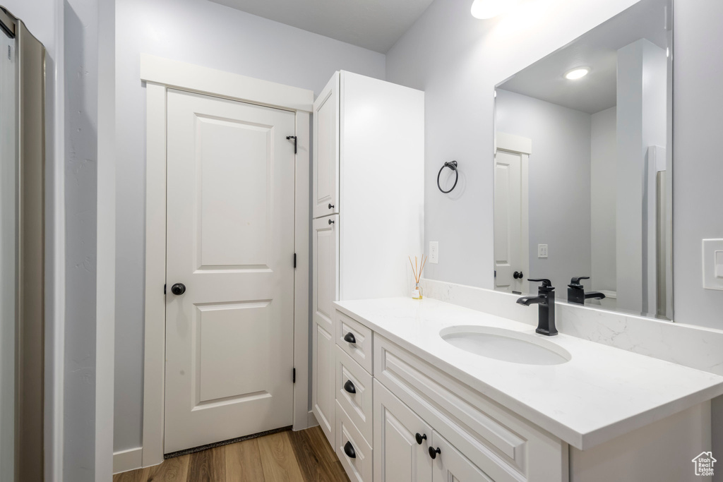 Bathroom featuring vanity and wood finished floors