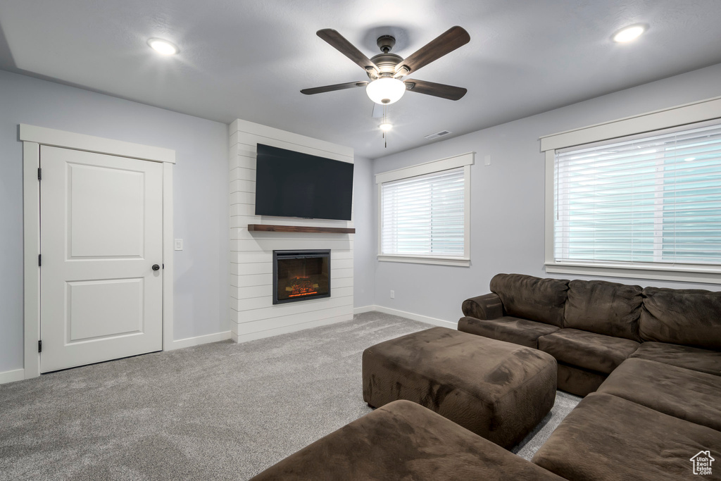 Living area with baseboards, ceiling fan, carpet floors, a fireplace, and recessed lighting