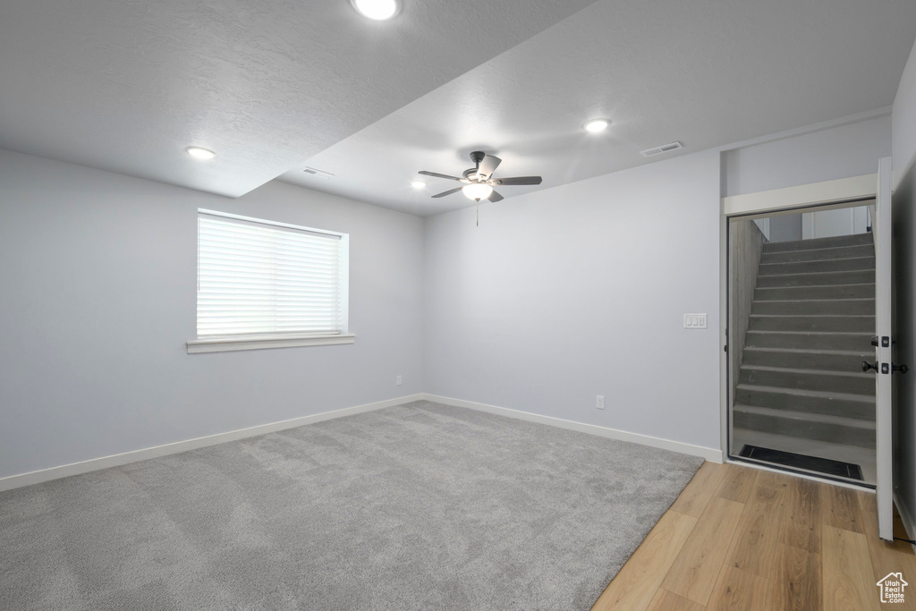 Unfurnished room with stairway, a ceiling fan, recessed lighting, baseboards, and wood finished floors