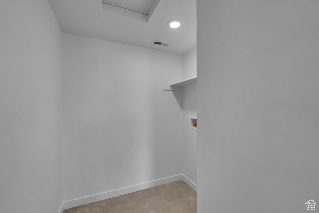 Laundry room featuring hookup for a washing machine, baseboards, and attic access