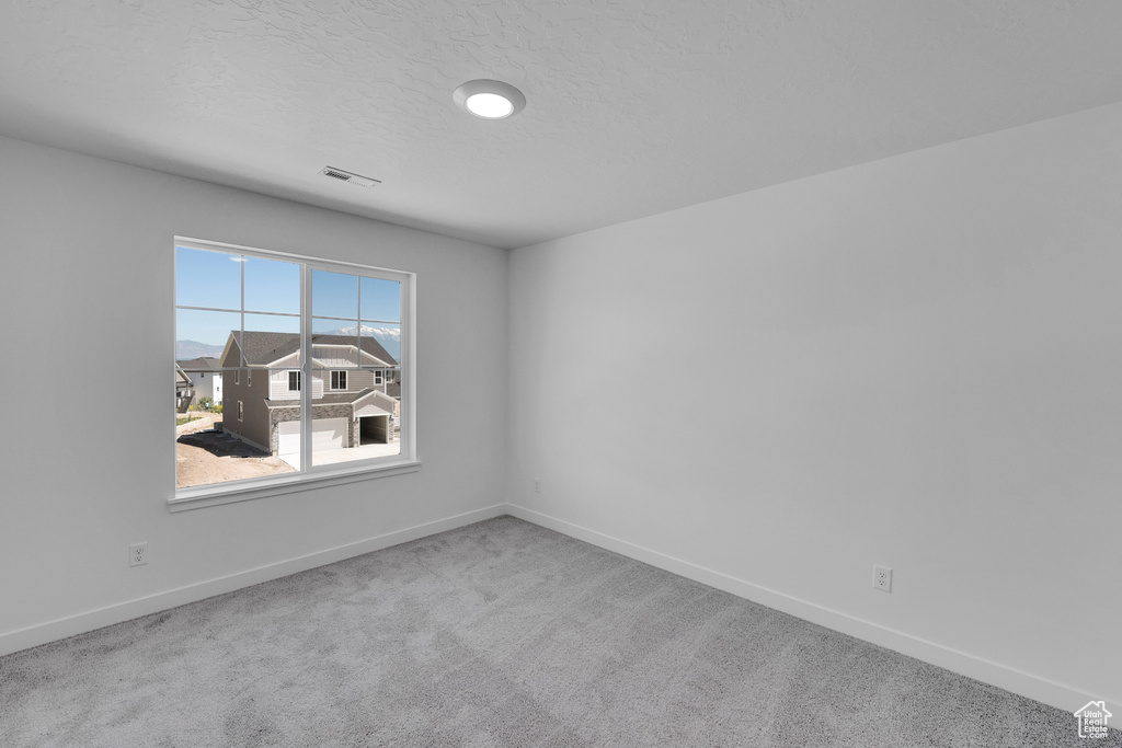 Unfurnished room with carpet floors and baseboards