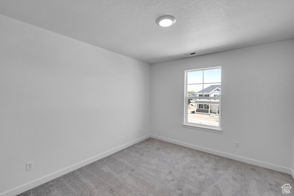 Carpeted empty room with baseboards