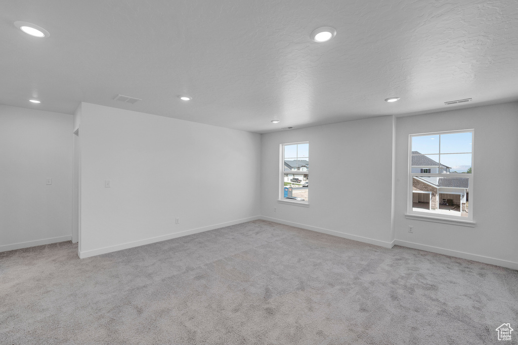 Unfurnished room with recessed lighting, carpet, and baseboards