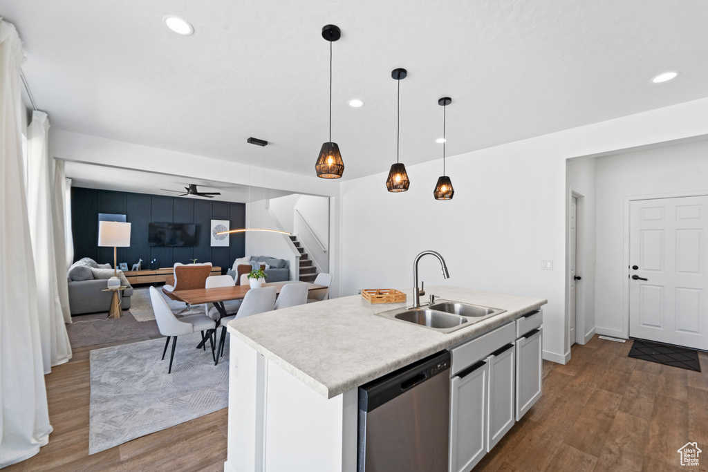 Kitchen featuring dishwasher, a sink, a ceiling fan, wood finished floors, and recessed lighting