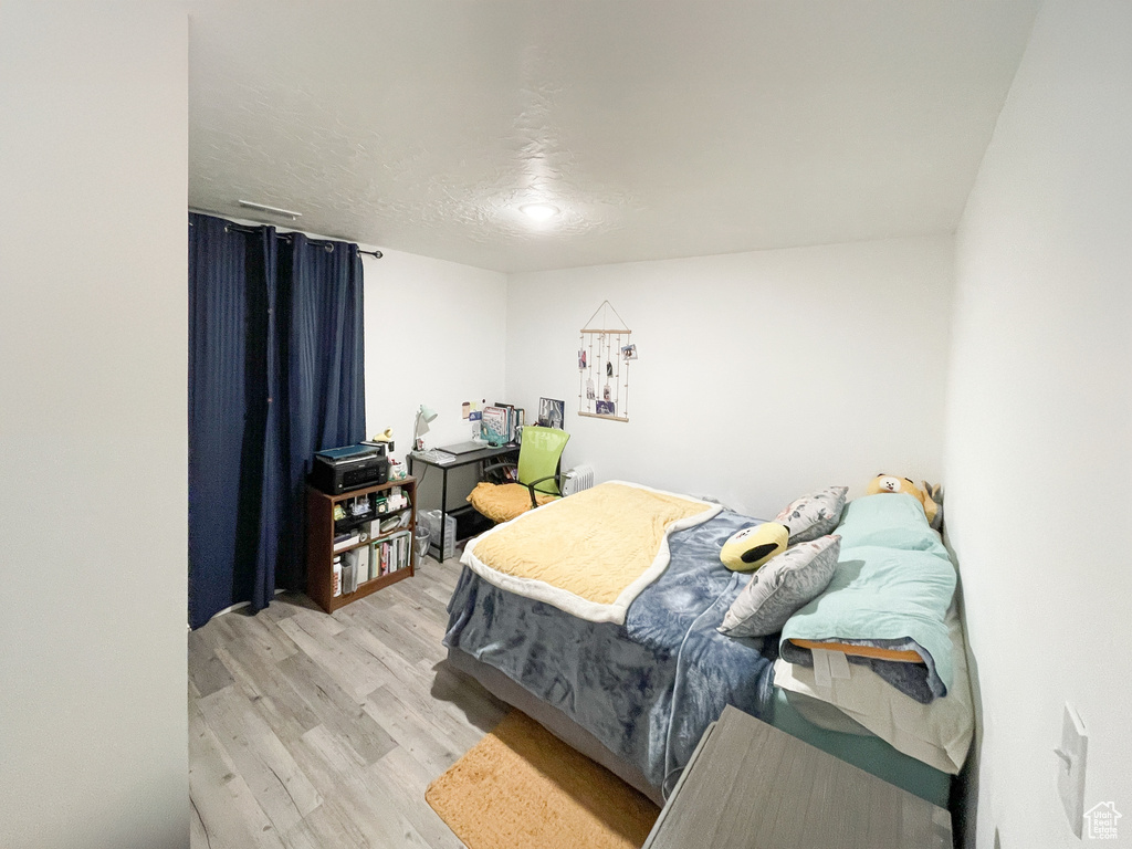 Bedroom with light wood-style flooring