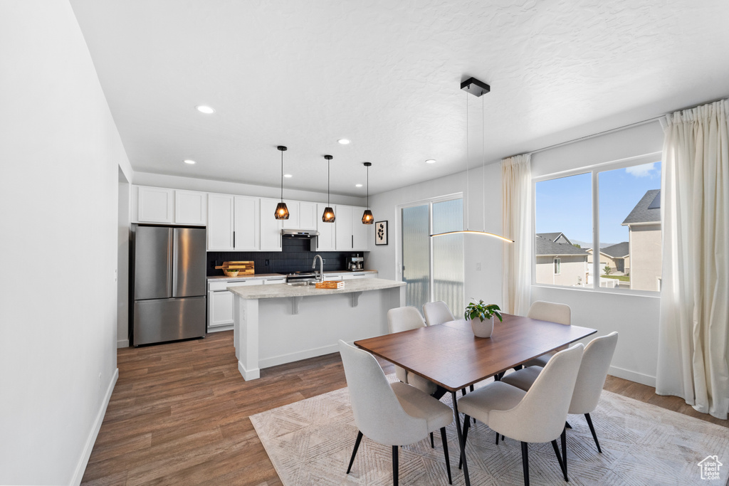 Dining area featuring wood finished floors, recessed lighting, and baseboards
