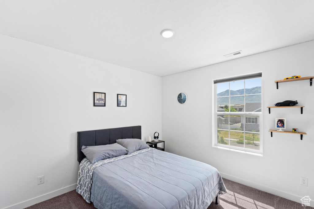 Carpeted bedroom featuring baseboards