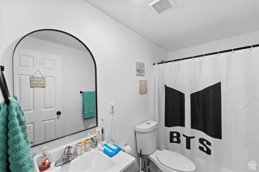 Bathroom featuring toilet and vanity