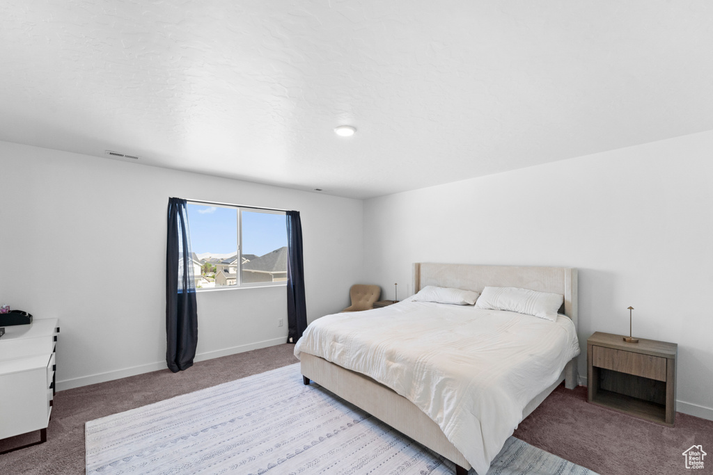 Bedroom with carpet flooring and baseboards