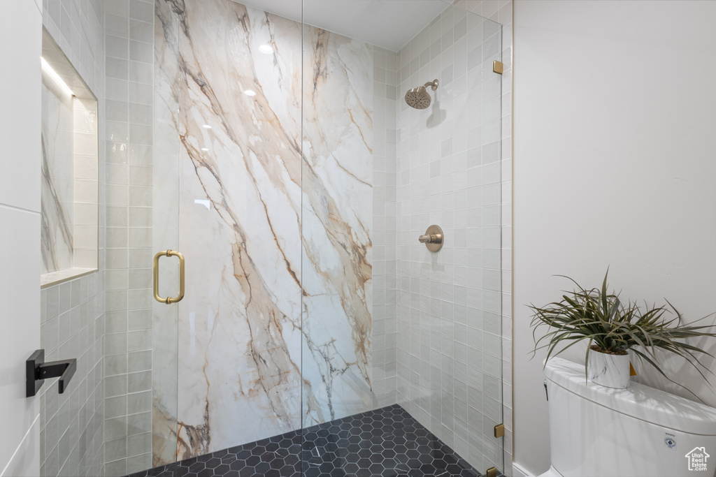 Full bathroom with a stall shower and toilet