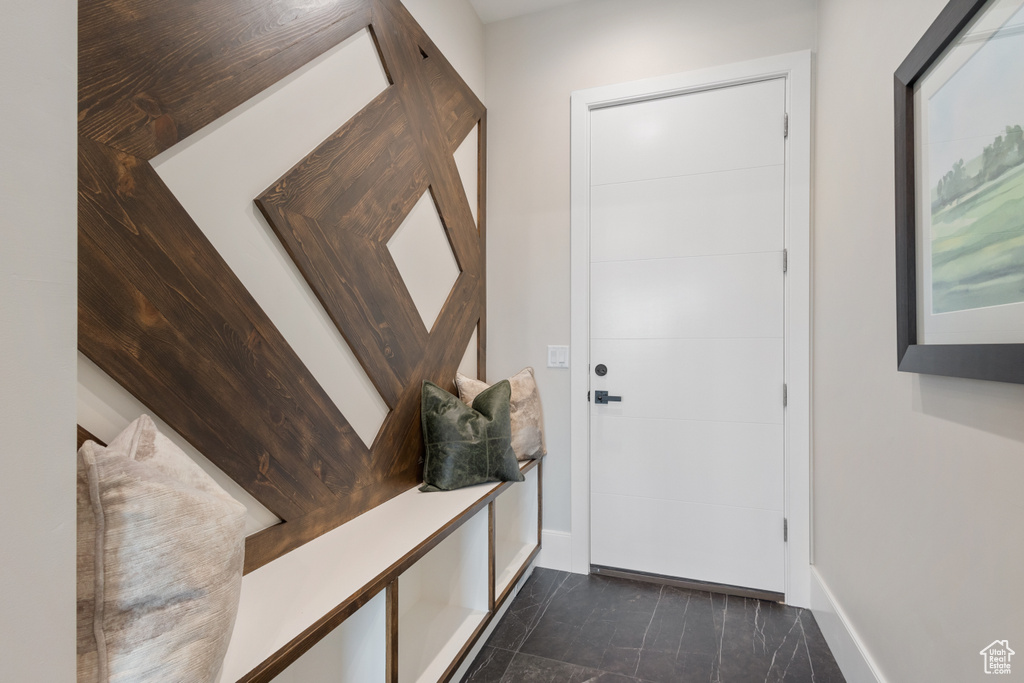 Doorway featuring baseboards