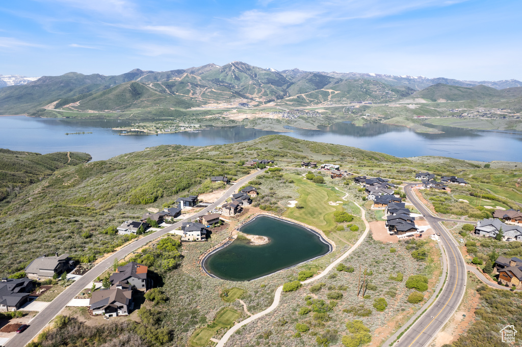 View of property location with a water and mountain view and nearby suburban area