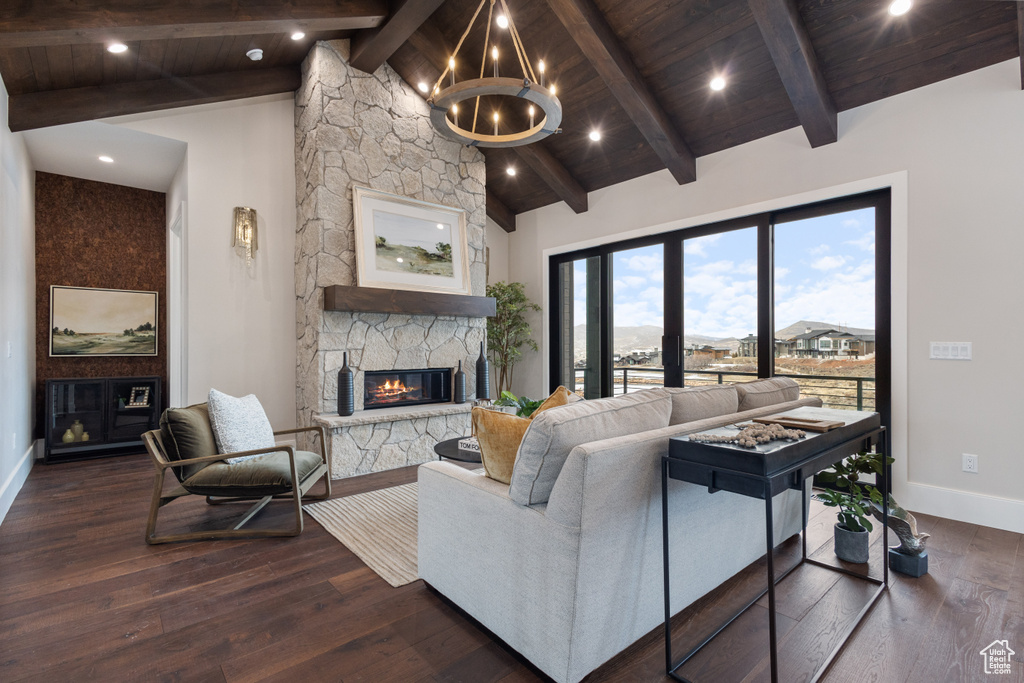 Living room with a fireplace, baseboards, dark wood finished floors, wood ceiling, and recessed lighting