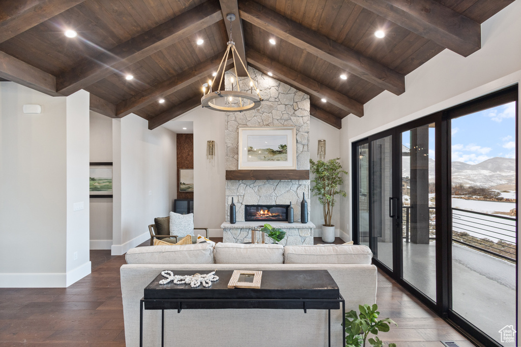 Living area featuring wooden ceiling, a mountain view, baseboards, dark wood-style floors, and a fireplace