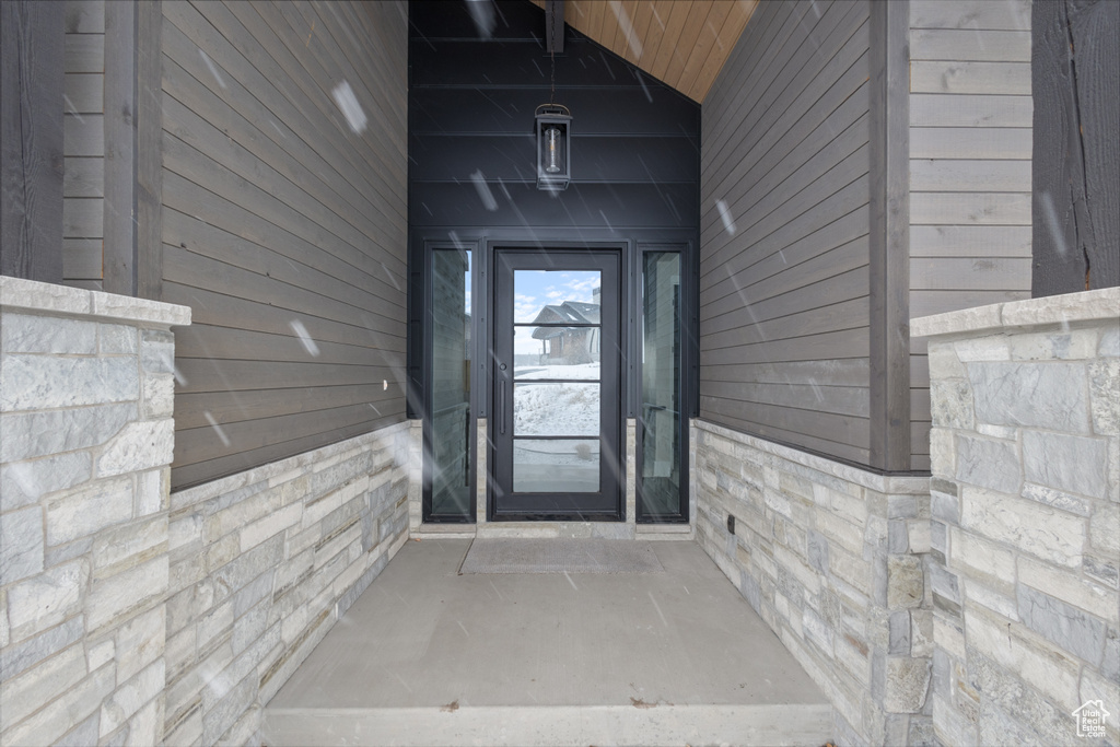 Entrance to property with stone siding