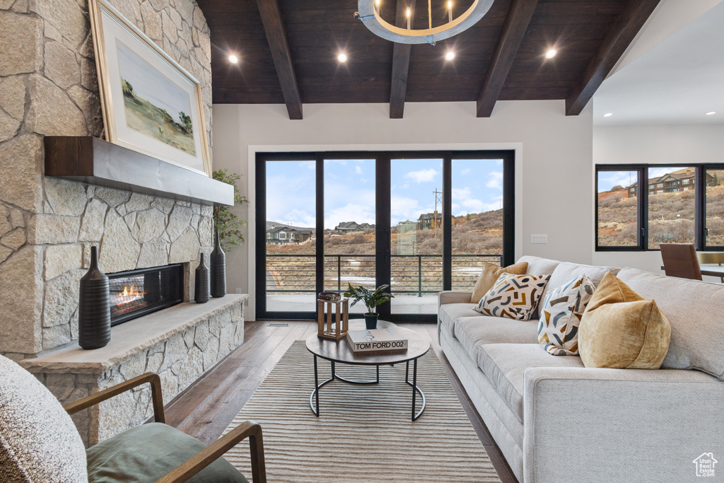 Living room featuring wood-type flooring, a fireplace, wooden ceiling, and recessed lighting