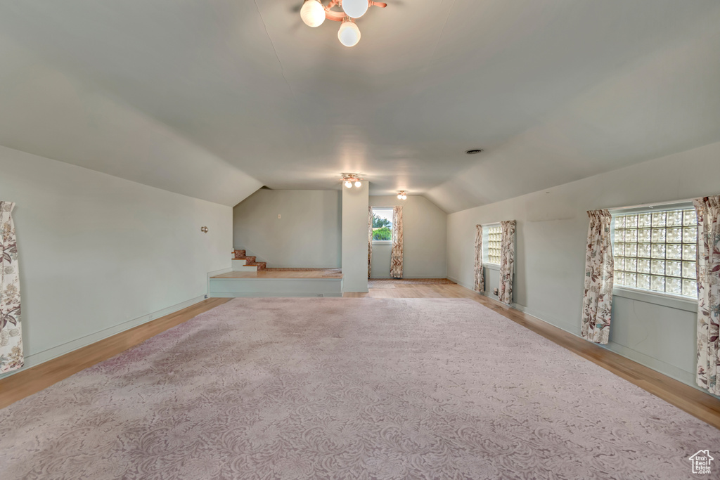 Bonus room featuring wood finished floors and lofted ceiling
