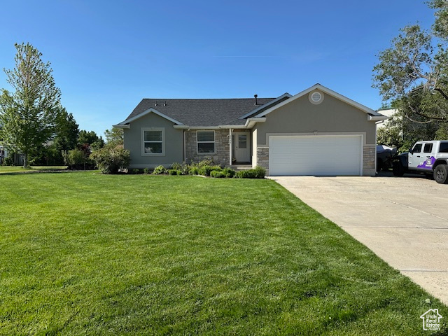 Ranch-style house with concrete driveway, an attached garage, a front lawn, stone siding, and stucco siding
