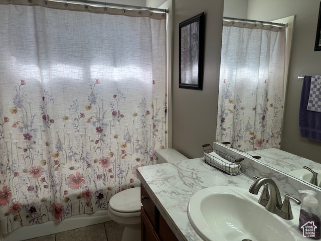 Full bathroom with vanity, toilet, and tile patterned flooring
