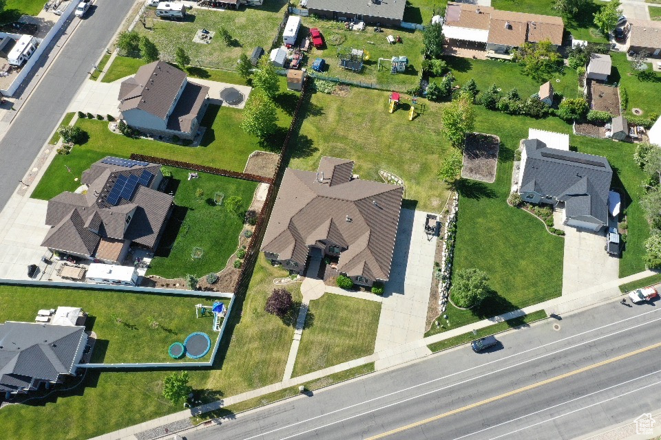 Aerial view of property and surrounding area with nearby suburban area