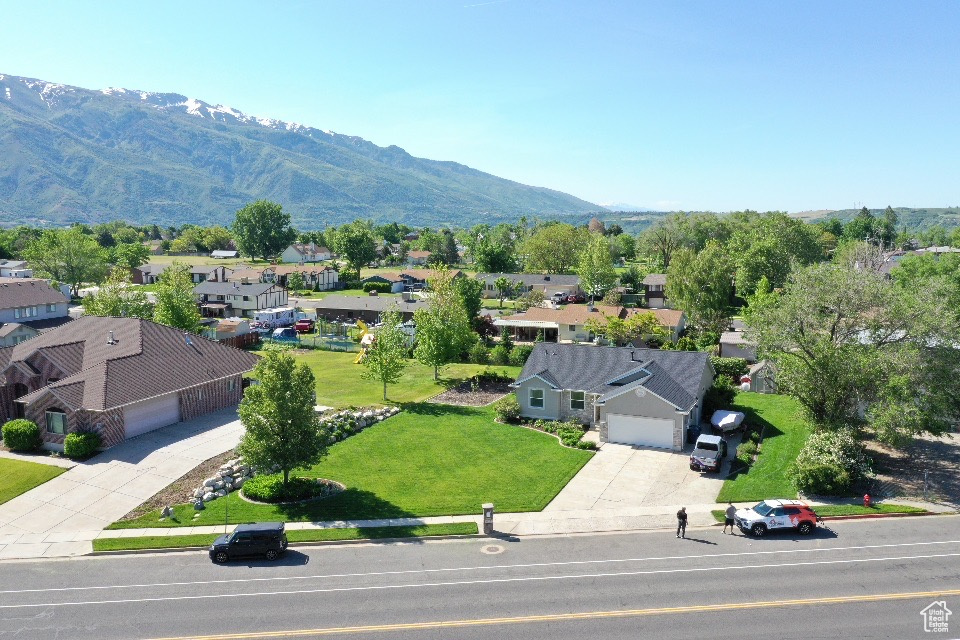 Aerial view of residential area featuring a mountainous background
