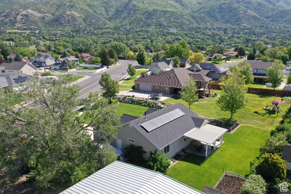 Aerial perspective of suburban area with a mountainous background