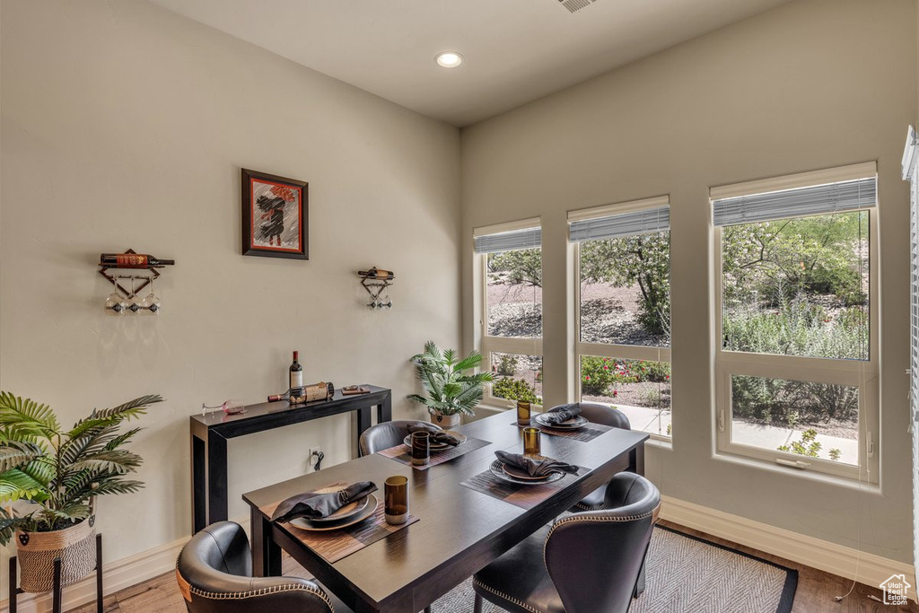 Dining area with baseboards, wood finished floors, and recessed lighting