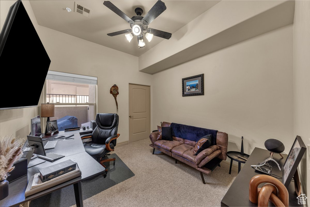 Office area with carpet floors and a ceiling fan