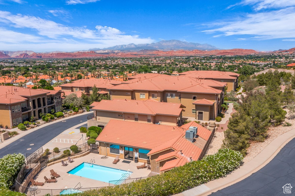 Aerial perspective of suburban area with a mountainous background and a pool area