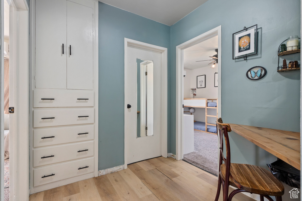 Foyer entrance featuring light wood-style floors, ceiling fan, and baseboards