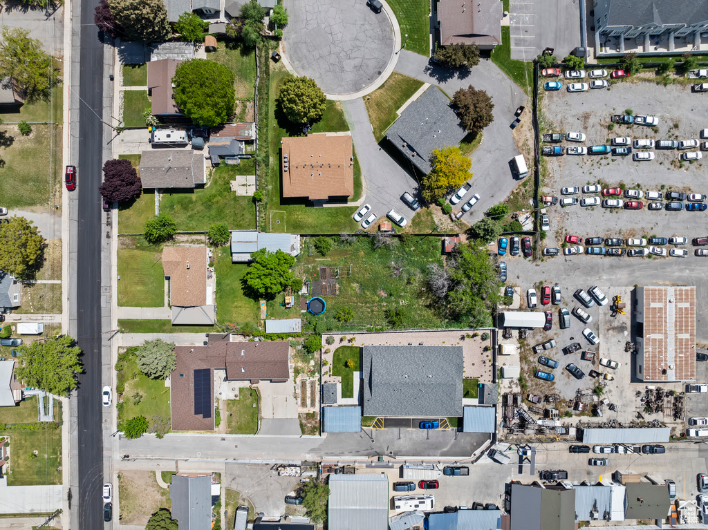 Aerial view of property and surrounding area with nearby suburban area