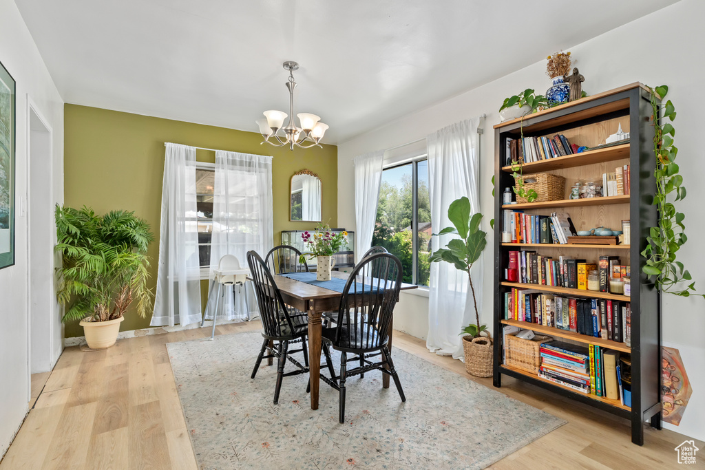 Dining area with a chandelier and wood finished floors