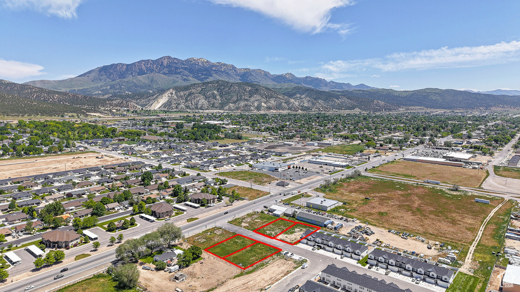 Aerial overview of property\'s location featuring property parcel outlined and a mountain backdrop