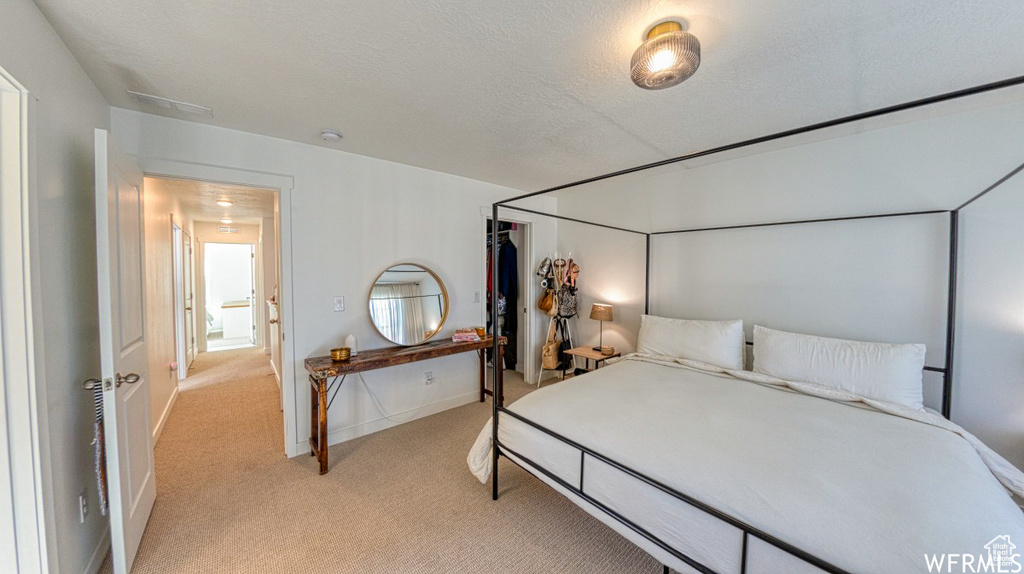 Bedroom featuring light colored carpet