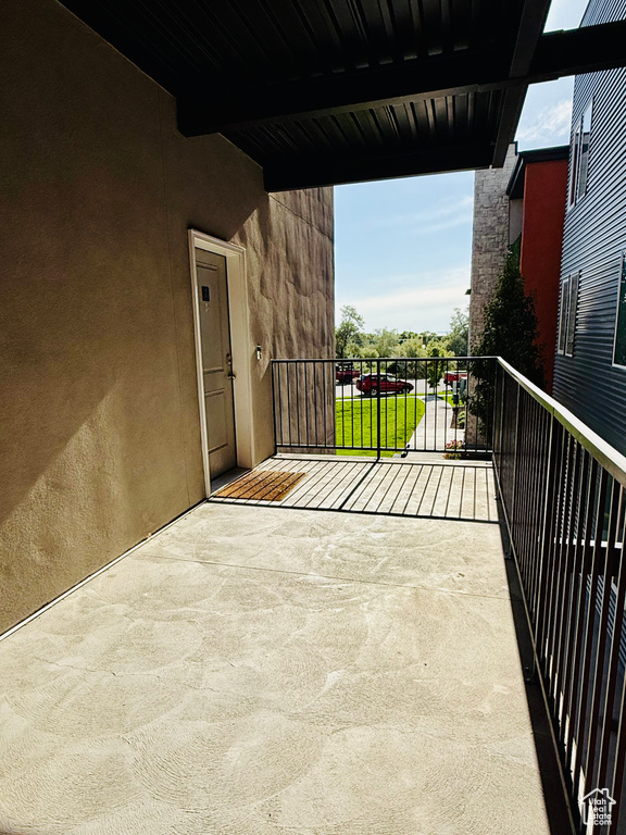 View of patio featuring a balcony